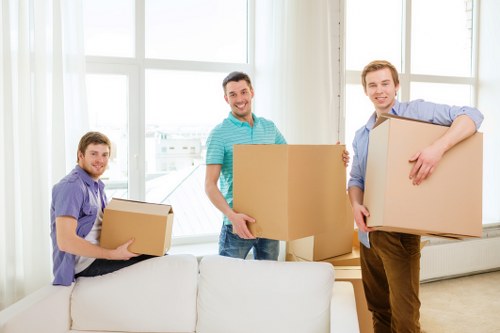 Local movers unloading boxes at a North London property